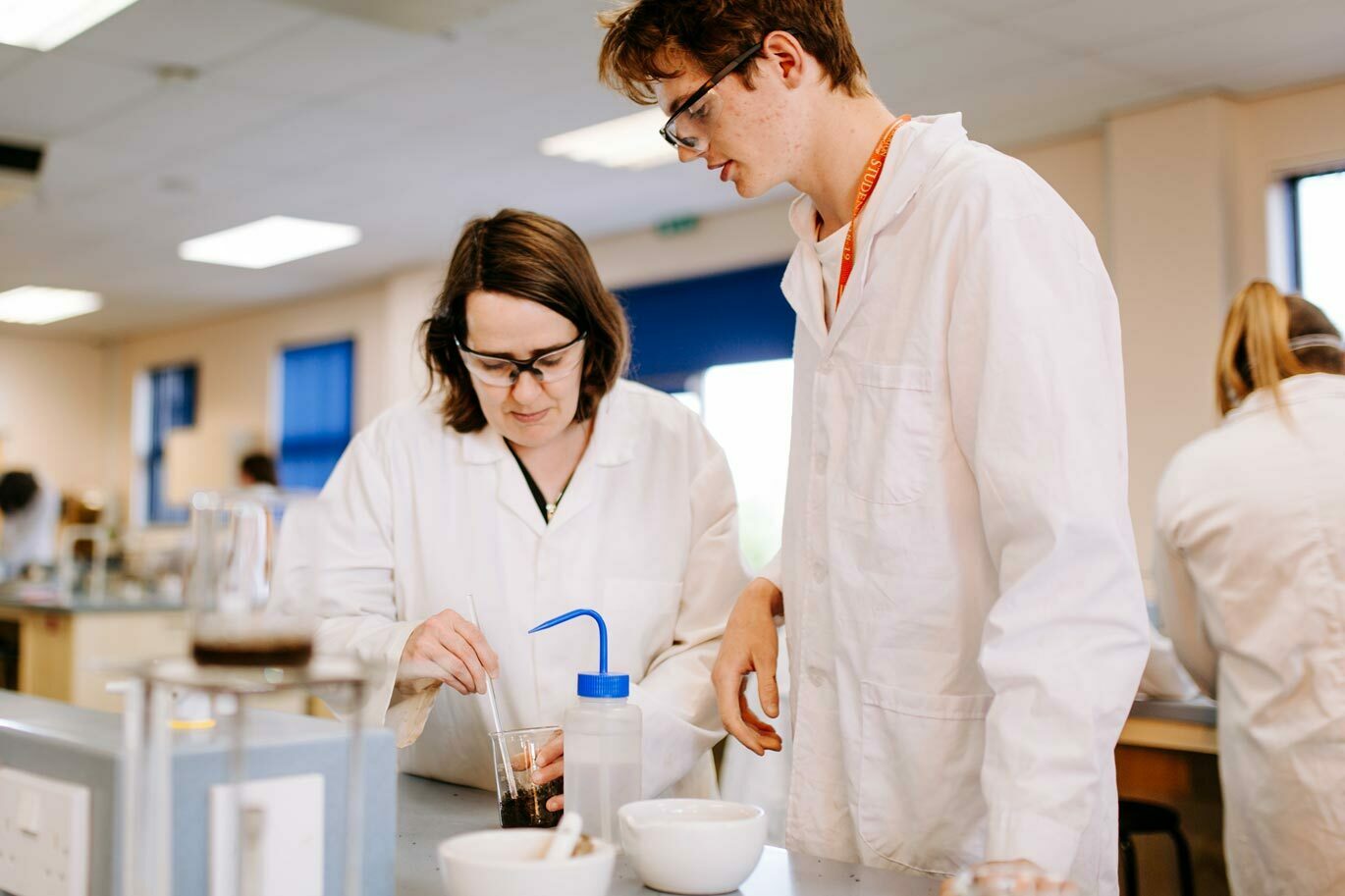 Forensic gallery Science tutor working with student in lab